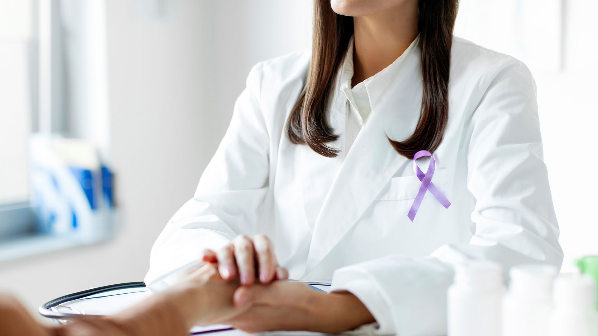 Female doctor in white coat with purple ribbon talking with patient. Alzheimer's disease, Pancreatic cancer, Hodgkin's Lymphoma awareness
