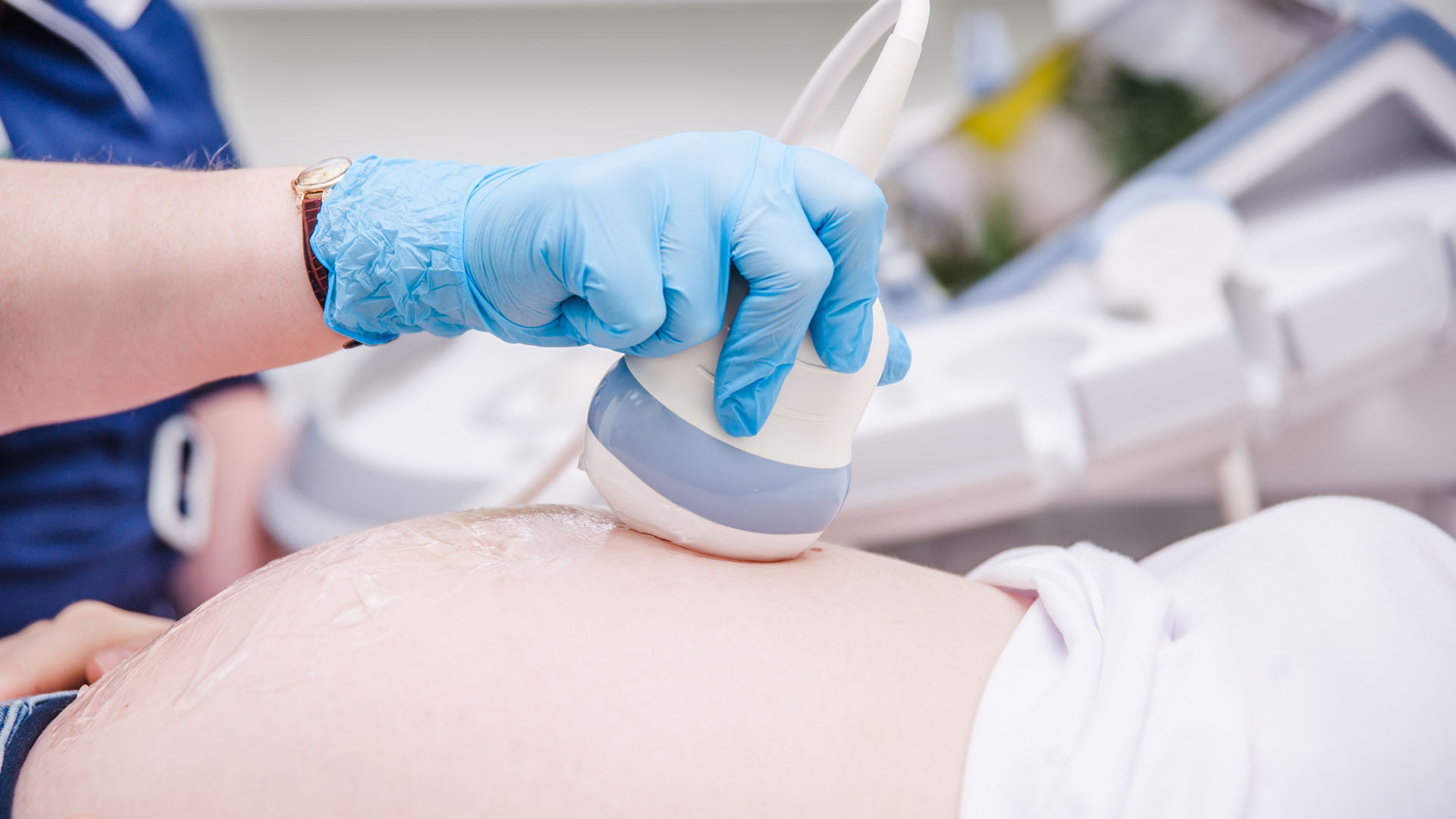 Close up of a pregnant woman having ultrasound scanning at the m